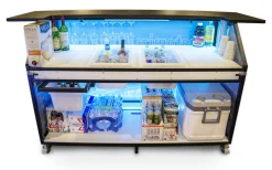 Signature 62 Bar w/ Bottom Storage Shelf - 2 Ice Bins - No Speed Rail - One Slide Out Storage Bin Signature 62 portable bar featuring LED-illuminated workspace with ice bins, glassware storage, and bottom storage shelf packed with beverages and supplies for catering and mobile bartending events