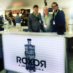 Signature 62 portable bar for spirits sampling featuring custom backlit branding at industry event LED-backlit portable bar counter displaying custom gin brand graphics at exhibition