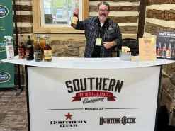 Fusion 48 Portable exhibition bar counter with custom branded graphics for liquor tastings and events Portable bar counter with Southern Distilling Company branding at bourbon tasting event