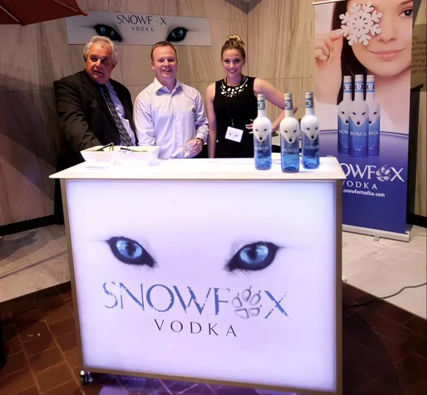Fusion 48 portable bar with LED backlit branding for spirits tastings and promotional events Portable branded bar setup for Snowfox Vodka tasting and sampling event