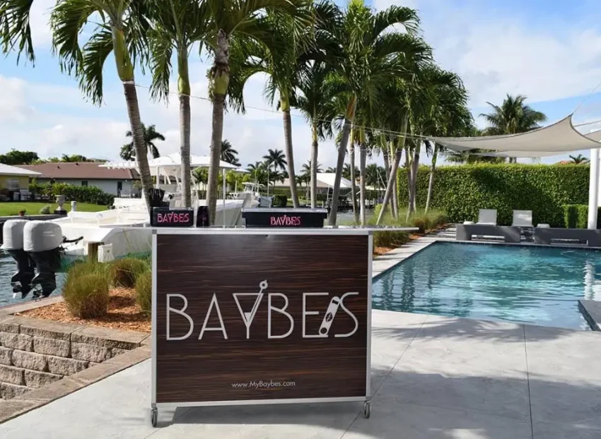 Fusion 48 Portable Bar - Upscale Mobile Bartending Station for Poolside Service Fusion 48 portable folding bar featuring custom branding set up at a poolside venue, showcasing the compact footprint ideal for luxury outdoor mobile bartending.