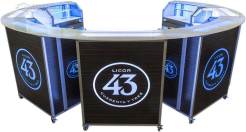 Minibar portátil - Montaje circular modular Siete unidades de bar portátiles Mobile Mini con tapas curvas conectadas para formar una estación de bar semicircular con la marca Licor 43.