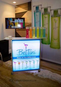 Mobile Mini Portable Bar - Be Tini Trade Show Setup Mobile Mini portable bar on wheels with Be Tini branding at indoor trade show event